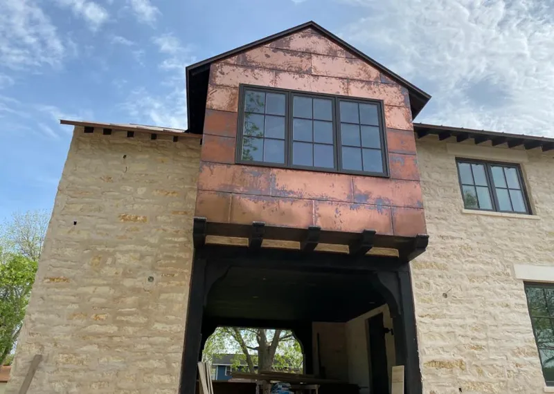Copper metal panel facade on a stone building for Skylight Installation in Daphne