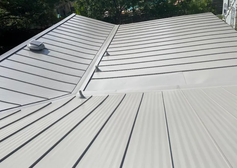 Solar attic fan installed on a metal roof for Roof Ventilation in Daphne